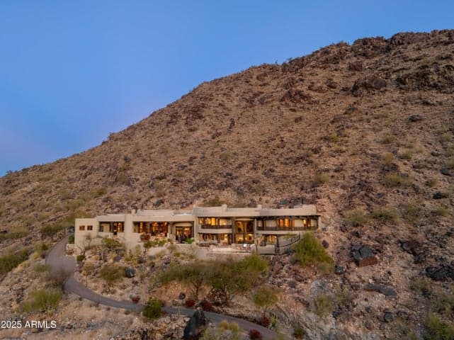 Discover an exceptional residence tucked within one of Paradise Valley’s most prestigious gated communities. Carved directly into the mountainside, this custom-built estate features multiple terraces, lush desert landscaping, and a discreet driveway that leads to a world of exclusive privacy and luxury.