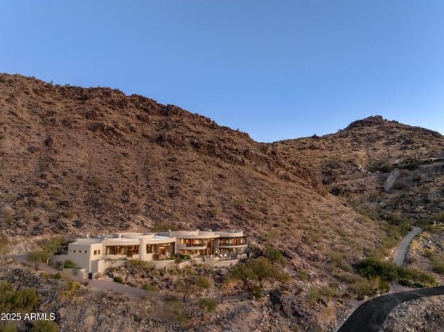 Perched high on the rugged slopes of Mummy Mountain, this custom home offers extraordinary seclusion and panoramic desert views. The home’s commanding position enhances energy efficiency while embracing the raw beauty of the surrounding Sonoran landscape—an ideal retreat for those craving tranquility and style.