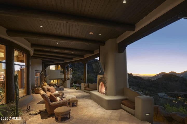 An entertainer’s dream, this expansive covered patio offers warmth and ambiance with a built-in fireplace and comfortable seating areas. Enjoy elevated views of the city lights and mountains under a beautifully crafted wood ceiling.