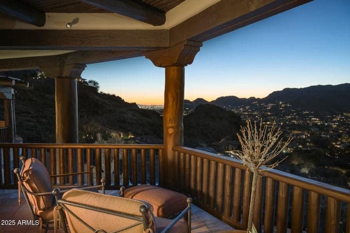 Enjoy breathtaking mountain and city light views from the primary suite's private patio. This covered outdoor space offers a peaceful setting to take in Arizona sunsets while nestled in the hills of prestigious Paradise Valley.