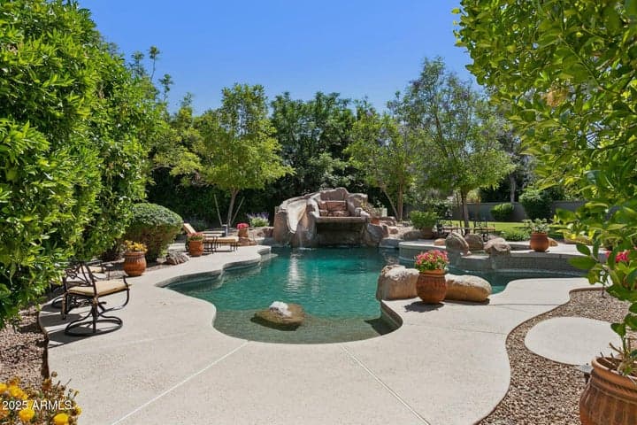 lagoon pool and spa surrounded by mature citrus trees