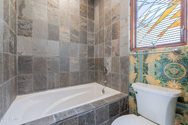 Jetted tub/shower combination, stained and leaded glass window