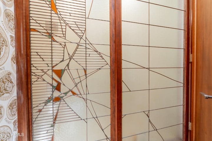 The 3/4 bath features sliding stained and leaded glass doors to conceal the walk-in shower