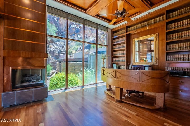 Copper framed fire place and copper accented mahogany walls with custom designed desk