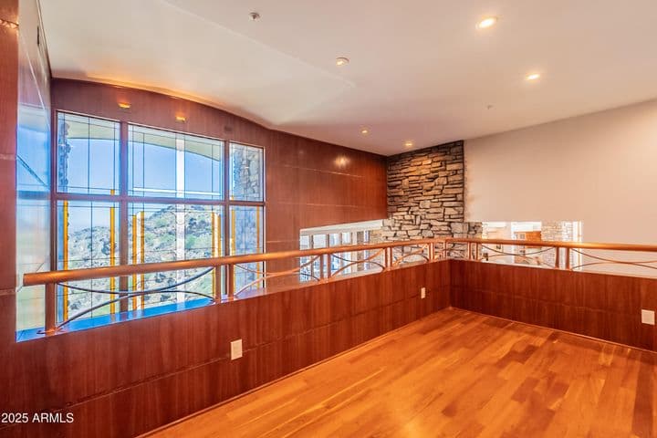 The two-story stained and leaded glass stretches to the primary floor