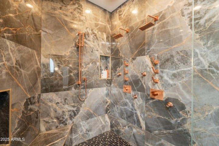 Multiple shower heads and accessory features with floor to ceiling design