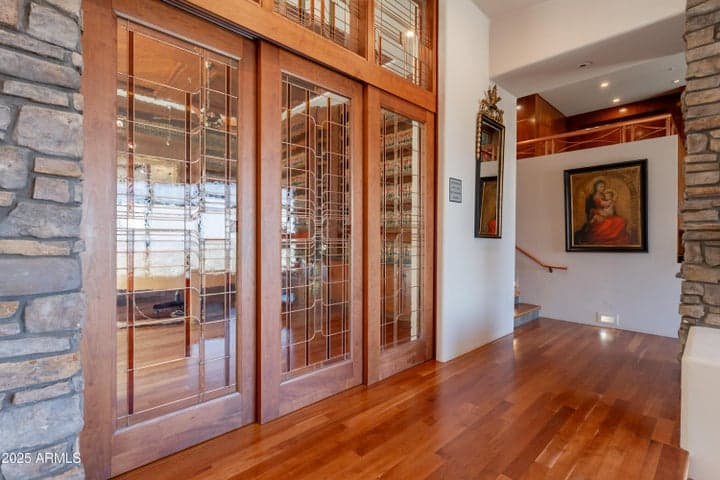 One-of-a-kind office entry with detailed pocket doors and transom windows