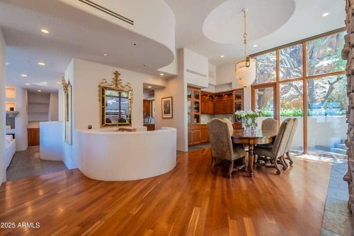 Ideal flow from living to dining. Notice the spiral staircase entry to the speakeasy below