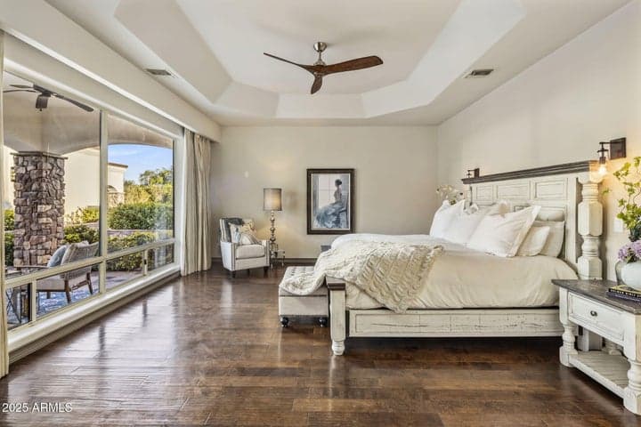 The primary bedroom offers elegance space and refined comfort. Motorized retractable window treatments brings ease for privacy
