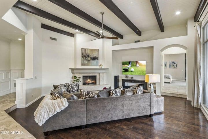 Rich hardwood, custom millwork and cozy fireplace with rough-hewn mantle