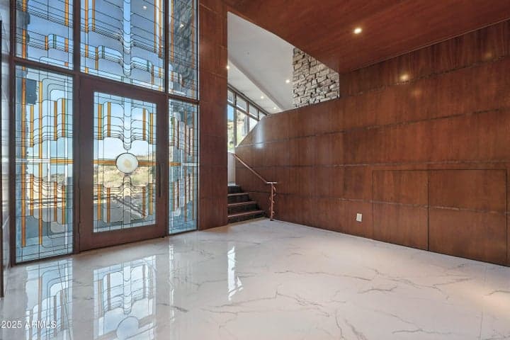 Rich mahogany wood detail with copper trim and two-story stained and leaded glass entry