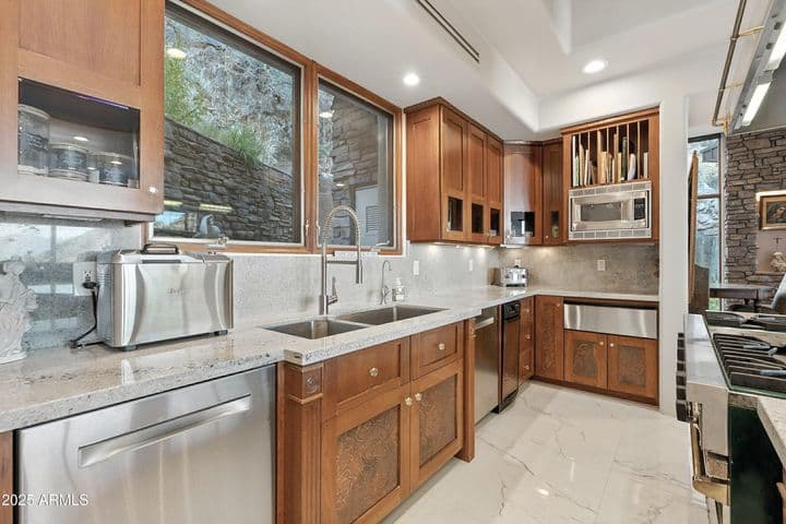 Generous counter space, island seating and skylight to bathe the space in natural light