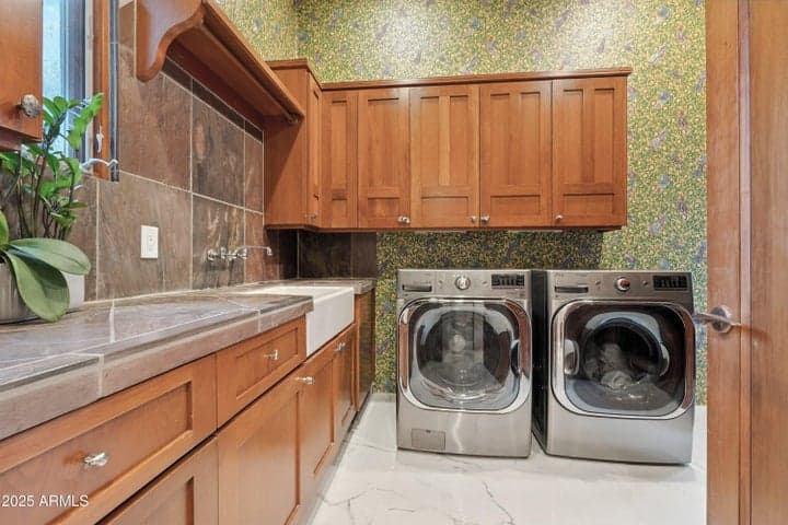 Custom built in cabinetry, deep apron sink, natural light and washer & dryer convey