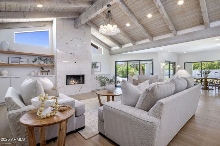 Great room open to Kitchen and breakfast Room, with Fireplace overlooking 1,000 sq.feet of covered patio, yard and pool.