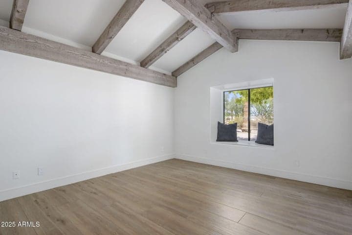 Jack & Jill Bedroom #1 with wood beams and window seat with hinged lid for toybox or storage (both bedrooms)