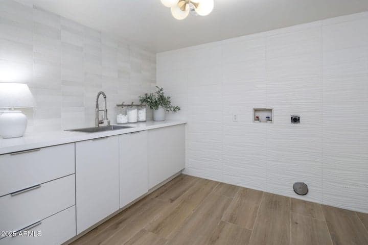 sink and beautiful cabs in laundry room