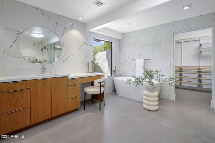 Primary Bath, 1 of the 2 lav stations, vanity and bathtub overlooking private courtyard