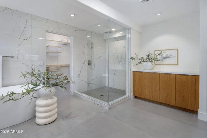Gorgeous glass enclosed shower and additional cabinetry